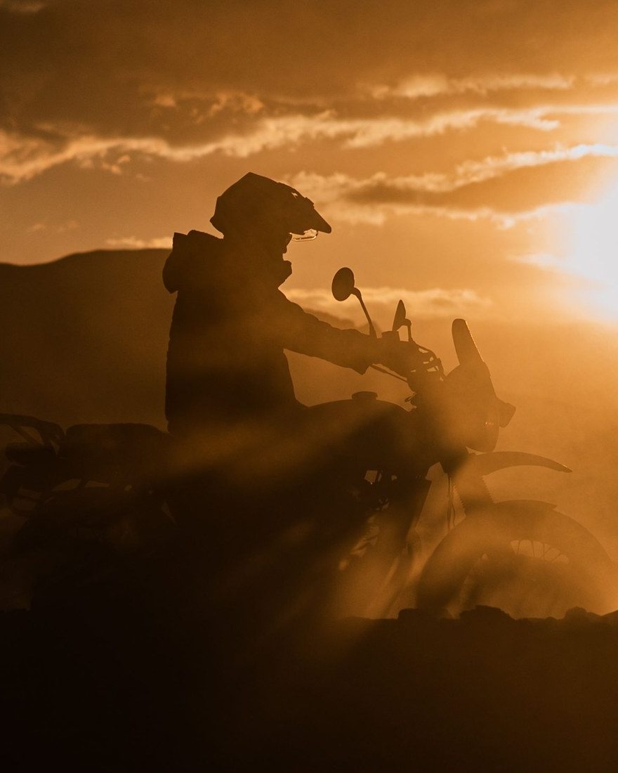 Rider on an adventure motorcycle at sunset